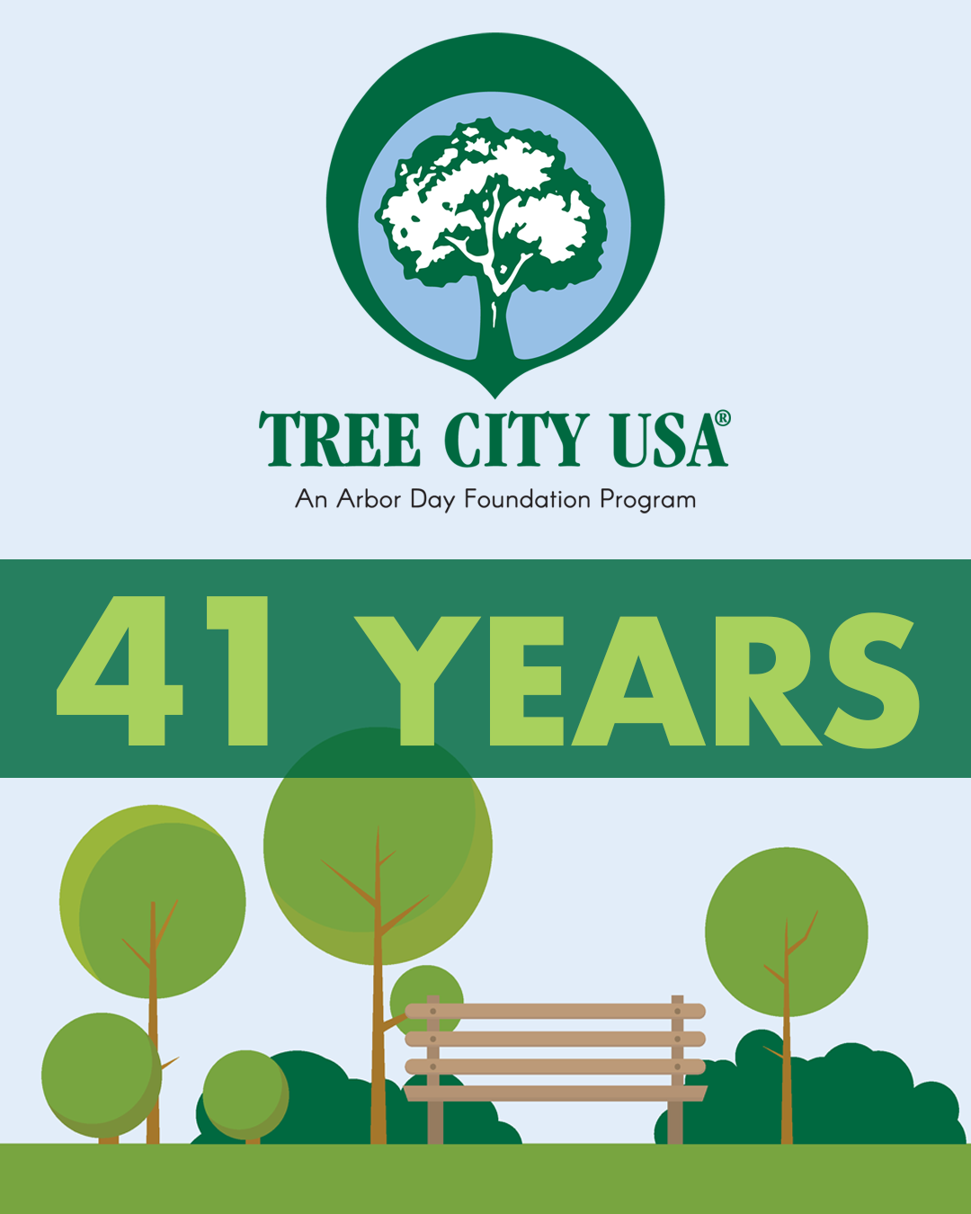 41 Years Tree City USA with trees and bench and blue sky